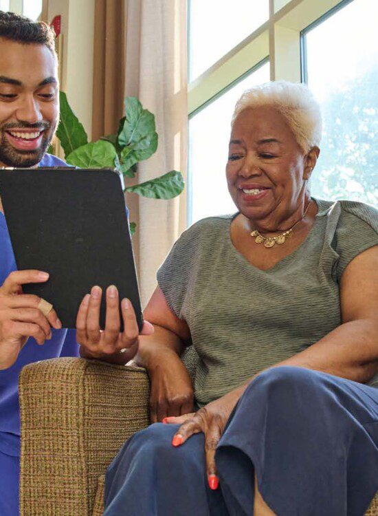 Man showing woman an iPad