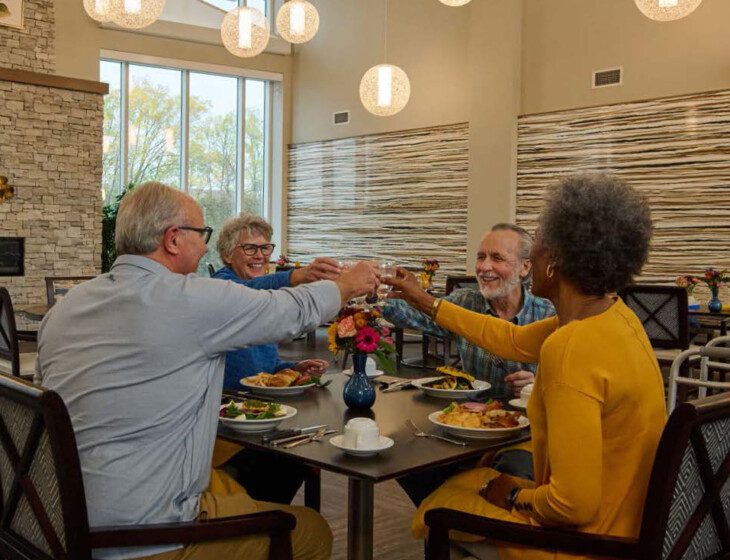 Four adults at table having drinks